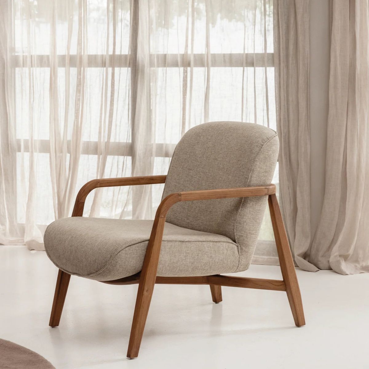 Minimalist lounge chair with walnut frame and cream upholstery